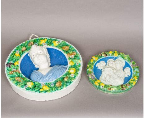 A 19th century Italian Cantagalli maiolica pottery relief plaqueOf circular form, centred with the bust of a child, in a frui