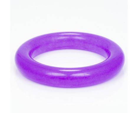 A lavender jade bangleOf plain circular form.  8.5 cm diameter.  CONDITION REPORTS: Generally in good condition, some general