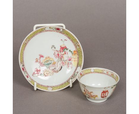 An 18th century Chinese famille jeune porcelain tea bowl and saucerDecorated with figures and objects in an interior.  The te