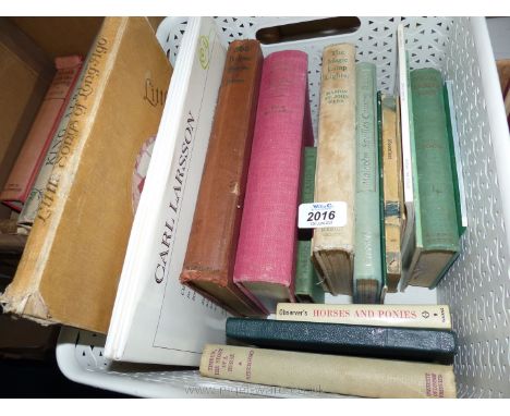 A white basket of children's books including The Magic Lamp Lighter, 365 Bedtime stories, Little songs of Long ago, etc.