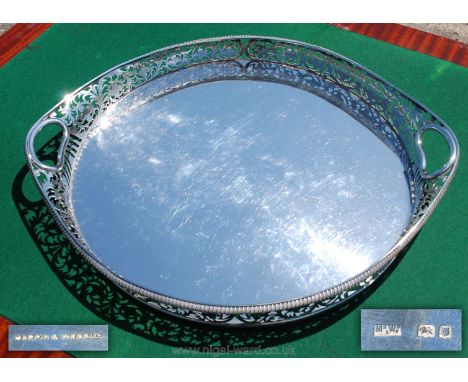 A superb Silver Tea Tray of large dimensions having a galleried edge profusely decorated with pierced work trailing stylised 