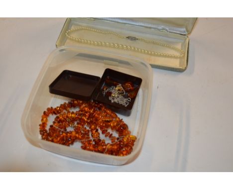 A box containing two amber necklaces and ear-rings; and a simulated pearl necklace 