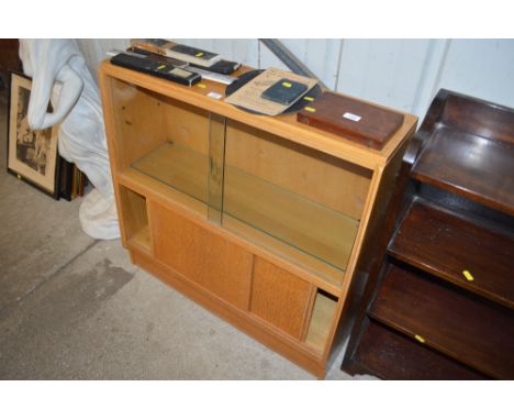 A G-plan light oak bookcase with sliding glass doors