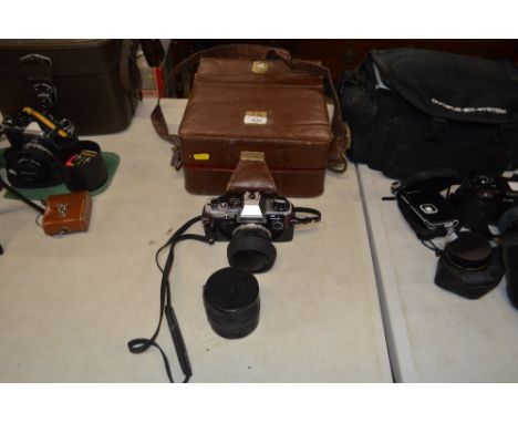 An Olympus OM10 camera; together with a lens case , and a carrying bag 
