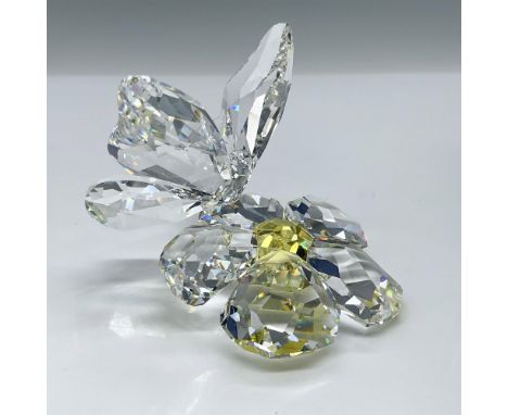 This figurine is made from clear faceted crystal, and the flower has a Jonquil (light yellow) center. Swarovski acid backstam