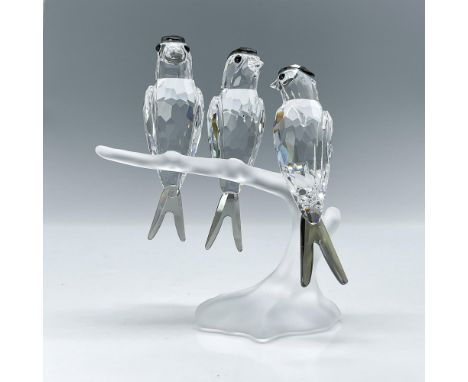 Three clear faceted crystal birds with black diamond stain crystal head and tail feathers. Perched on a frosted branch. Swaro