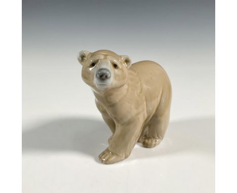 A glossy brown bear standing on all four. Lladro backstamp. This item has its original box: 7.75"L x 5"W x 3.75"H. Artist: Ju
