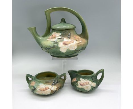 Earthenware tea service in green with light pink and white flowers in high-relief design. Roseville mark. Teapot 10"L x 8"W x