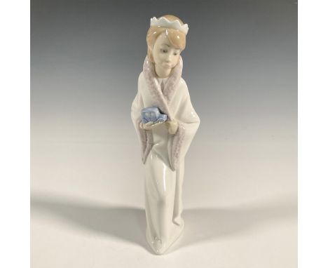 A glossy figure of a girl dress as a king holding a blue toy car. Lladro backstamp. Artist: Juan HuertaIssued: 1969-2001Dimen