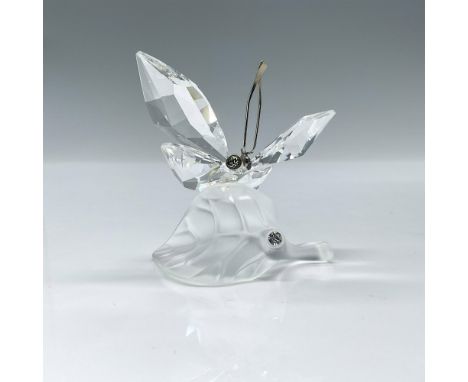 Clear faceted crystal figure of a butterfly with metal antennae resting on a frosted leaf. Part of the In the Secret Garden c