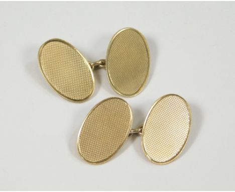 GOLD CUFFLINKS. A pair of 9ct. gold engine turned cufflinks. Approx. 6.8g.