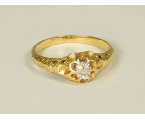 DIAMOND RING. A solitaire diamond ring set in yellow metal with engraved shoulders (probably 19th century). The cushion shape