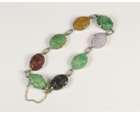 JADE BRACELET. A multi-coloured carved jade bracelet, set in 9ct. white gold.