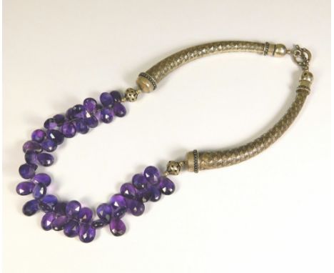 AMETHYST NECKLACE. A silver necklace hung with numerous faceted amethyst beads.