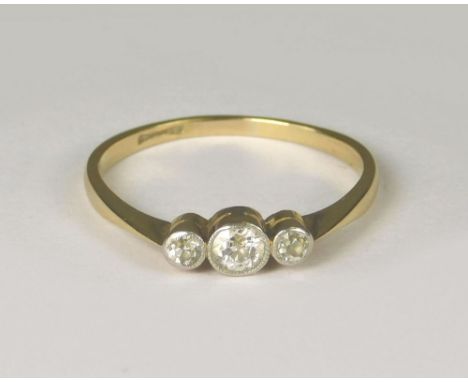 DIAMOND RING. An 18ct. gold &amp; platinum, three stone diamond ring, the brilliant cut stones in millegrain settings. Size R