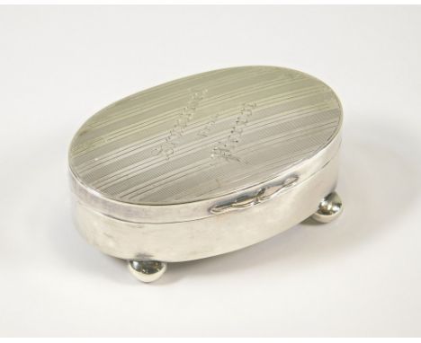 SILVER BOX. An oval engine turned silver box, the lid inscribed 'Scaramel from Pierrot'. Chester 1911. Retailer's mark for Ha