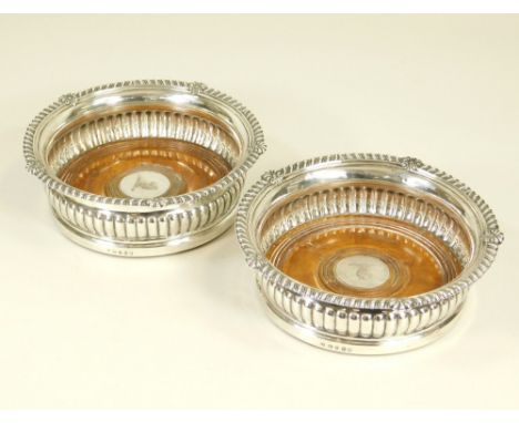 PAUL STORR. A pair of Paul Storr, George III silver wine coasters, each with half fluted sides with gadrooned & shell rims. E