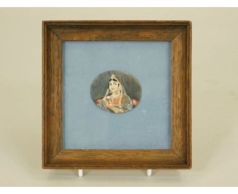 INDIAN MINIATURE. An Indian portrait miniature on ivory of a woman holding a rose. Unsigned. Image size 4 x 3.5cm.