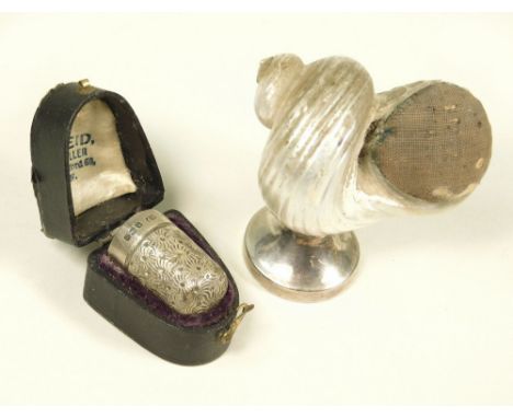 THIMBLE ETC. An Edwardian silver thimble in fitted case. Also a silver mounted mother of pearl shell pin cushion.