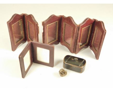 SNUFF BOX ETC. A 19th century papier mache snuff box &amp; contents. Also, two leather covered folding frames (largest a.f.).