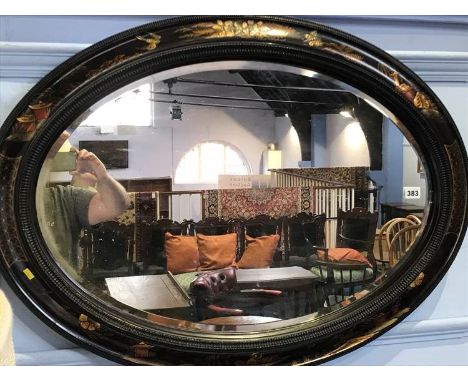 An Oriental lacquered standard lamp and oval mirror
