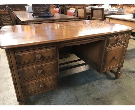 An Ercol desk, 139cm wide x 76cm deep