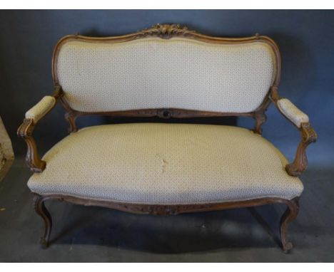 A Late 19th/Early 20th Century French Salon Sofa, the shaped carved and upholstered back above a stuff over seat with carved 