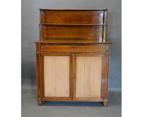 A Regency Rosewood Chiffonier with a brass galleried shelf back above a frieze drawer and a pair of fabric pleated doors rais