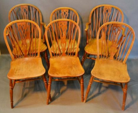 A Set of Six (4 plus 2) Early 19th Century Elm Windsor Dining Chairs, each with a pierced splat and spindle back above a pane