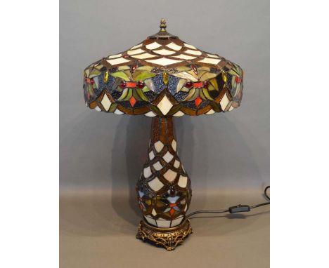 A Tiffany Style Glass and Metal Mounted Table Lamp with shade, raised upon circular pierced base, 59cm tall 