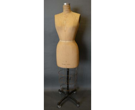 An Early Tailor's Dummy by the Superior Model Forms Corporation and with wrought iron stand, 145cm tall 