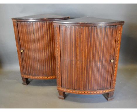 A Pair of 19th Century Mahogany and Marquetry Inlaid Corner Cabinets, each with a ribbed panel door and brass handle, raised 