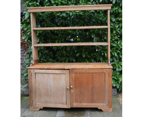 A 19th Century Pine Dresser, the open shelf back above two panel doors with brass knob handles raised upon bracket feet, 153c