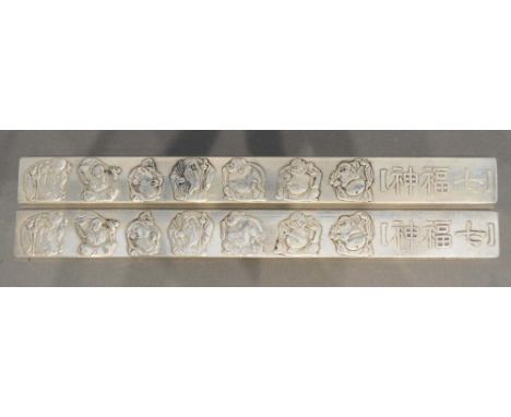 A Pair of Chinese White Metal Scroll Weights decorated in relief with figures, 23 x 2.5cm 