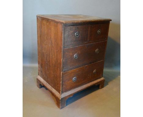 A 19th Century Oak Small Chest, the moulded top above two short and two long drawers with circular brass handles raised upon 