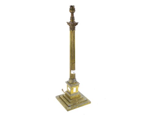 A Victorian brass candlestick modified into a lamp base. Modelled as a Corinthian column, height 49cm (excluding fitting)