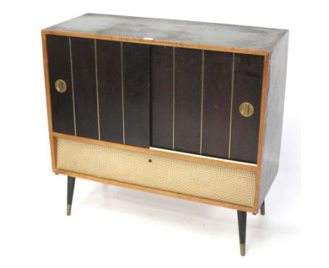 A 'His Master's Voice' radiogram. The cabinet containing a radio and a record player behind two panelled sliding doors, raise