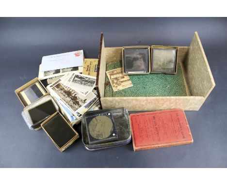An assortment of collectables. Including a collection of early glass negatives, magic lantern slides, photos and postcards, w