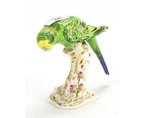 A Royal Worcester budgerigar. Perched on a stump, no 2664, H13.5cm