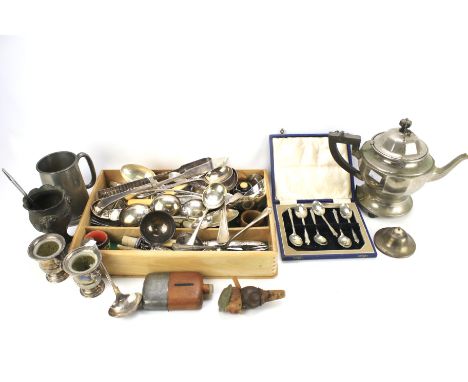 An assortment of silver plate and metalware. Including a teapot, hip flask, flatware, etc