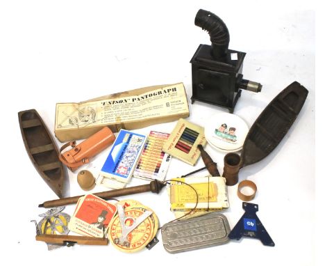An assortment of collectables. Including an enamel 'Caravan Club' badge, tinplate toy stove, two wooden boat hulls, artist ma