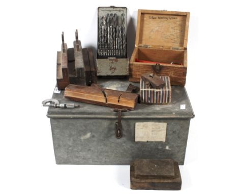 An assortment of tools within a metal twin handled case. Including drill heads, plains, blocks, etc