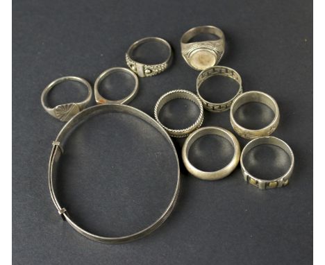 Nine silver and white metal rings and a silver bangle. Variously marked and stamped ‘925’