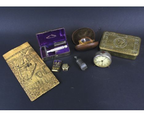 An assortment of collectables. Including a 1914 Christmas tin, Oris desk clock, compact razor, vintage whistle and a pair of 
