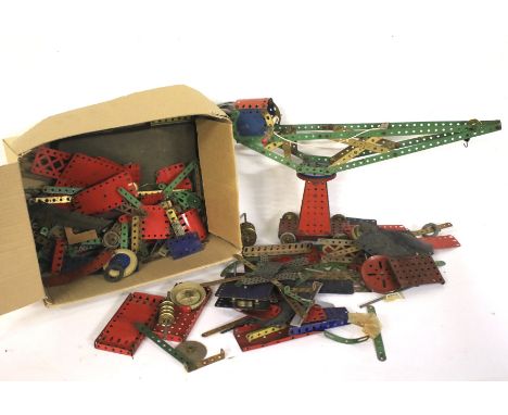 An assortment of vintage Meccano. Including plates, wheels, cogs, etc, in a variety of colours