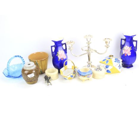 An assortment of ceramics and collectables. Including a Noritake ashtray, silver plated candlestick, cast metal model of a do