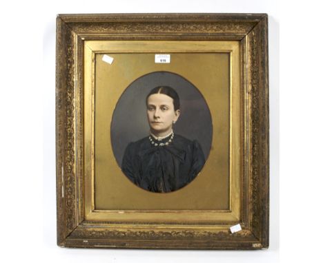 A Victorian studio photograph. Hand coloured head and shoulders portrait of a lady, oval mounted in a gilt frame, 26cm x 30cm