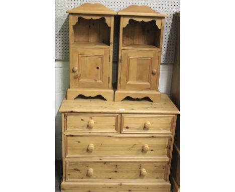 A pair of contemporary pine bedside cabinets and a chest of drawers. The bedside cabinets with a single shelf over a panelled