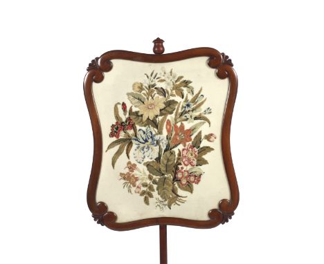 A Victorian mahogany rise and fall fire screen. With scroll shaped rectangular frame enclosing floral tapestry screen, on tur