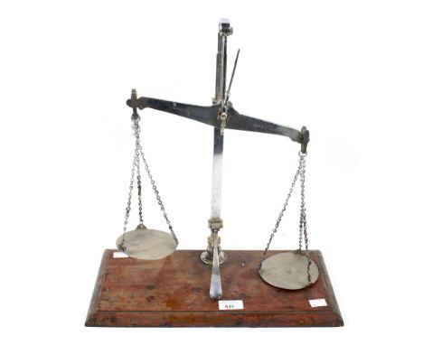 A chrome plated table top balance scale. Mounted on an oak base, 46cm high